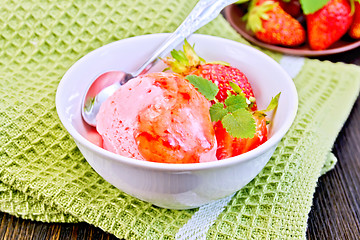 Image showing Ice cream strawberry with syrup and mint in bowl on board