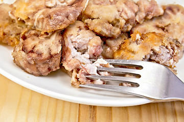 Image showing Brains fried in plate with fork on board