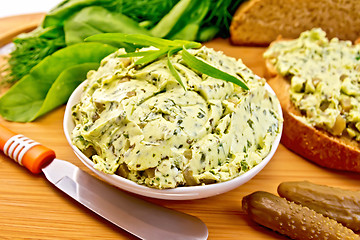 Image showing Butter with spinach and herbs in bowl on board