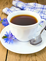 Image showing Chicory drink in white cup with flower on board