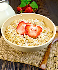 Image showing Oatmeal with strawberry on dark board