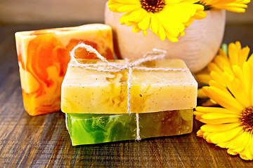 Image showing Soap homemade with calendula and mortar on board