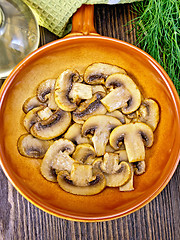 Image showing Champignons fried in ceramic pan top