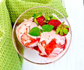 Image showing Ice cream strawberry with napkin on board top