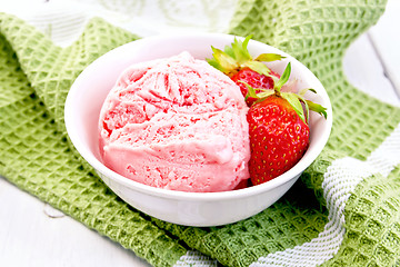 Image showing Ice cream strawberry in bowl on board and napkin