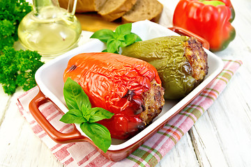 Image showing Pepper stuffed meat in brown roaster with basil 