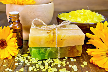 Image showing Soap homemade and salt with calendula on board