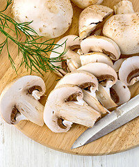 Image showing Champignons raw on board with knife