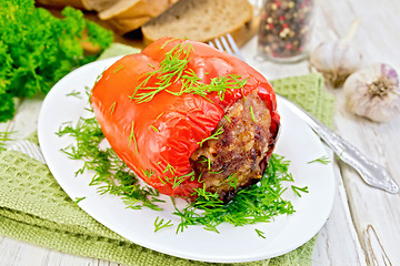 Image showing Pepper stuffed meat with dill in plate on board