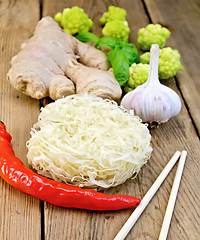 Image showing Noodles rice twisted with spices and broccoli on board