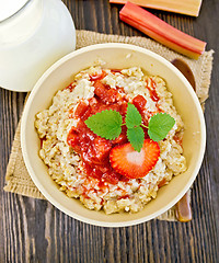 Image showing Oatmeal with strawberry-rhubarb sauce on board top