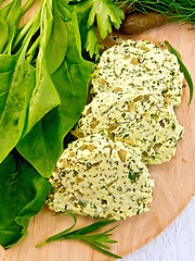 Image showing Butter with spinach and greens on board