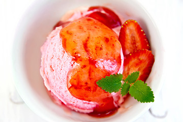 Image showing Ice cream strawberry with syrup on board top