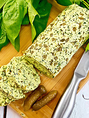 Image showing Butter with spinach and cucumbers on wooden board