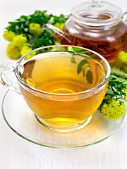 Image showing Tea of Rhodiola rosea in cup with teapot on board