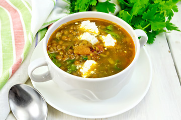 Image showing Soup lentil with spinach and cheese on light board