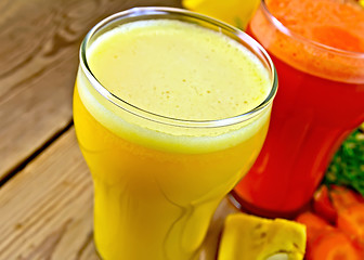 Image showing Juice pumpkin and carrot on wooden board