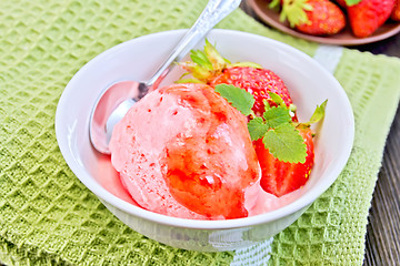Image showing Ice cream strawberry with syrup and spoon in bowl on board