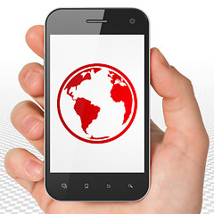 Image showing Learning concept: Hand Holding Smartphone with Globe on display