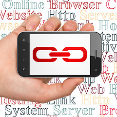 Image showing Web development concept: Hand Holding Smartphone with Link on display