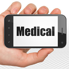 Image showing Medicine concept: Hand Holding Smartphone with Medical on display