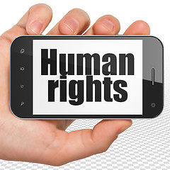 Image showing Politics concept: Hand Holding Smartphone with Human Rights on display