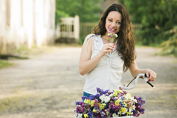 Image showing Happy girl with her bicycle