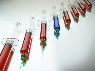 Image showing Red syringe among blue ones as right medical choice