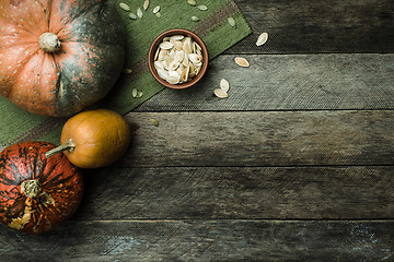 Image showing pumpkins and seeds in Rustic style on wood 