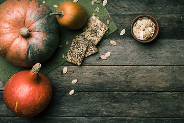 Image showing Rustic style pumpkins with cookies and seeds on wood. 