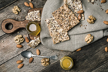 Image showing Cookies with seeds, nuts, honey on wooden table