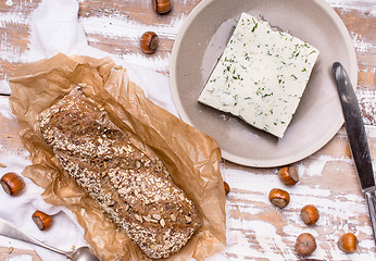 Image showing Bread with seeds and cheese for breakfast on table