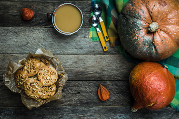 Image showing Rustic style pumpkins soup and cookies with seeds on wood