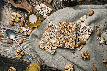 Image showing dietary Cookies with  honey and nuts on napkin and wooden table