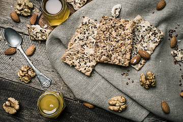 Image showing dietic cookies with honey and nuts on rustic table