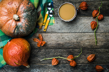 Image showing Rustic style pumpkins vegetable soup and ground cherry on wood