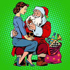 Image showing Christmas gift. Santa Claus and a beautiful girl