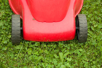 Image showing red lawnmower on green grass