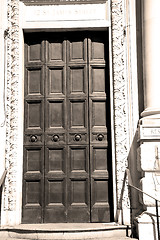 Image showing handle in london antique brown door  rusty  brass nail and light