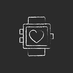 Image showing Smartwatch with heart sign icon drawn in chalk.