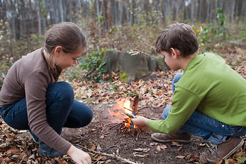 Image showing Children starting a campfire