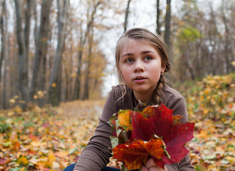 Image showing Girl and autumn leaves