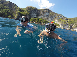 Image showing shoot of a young boy snorkeling with father