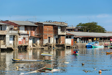 Image showing Straw poor houses by the river