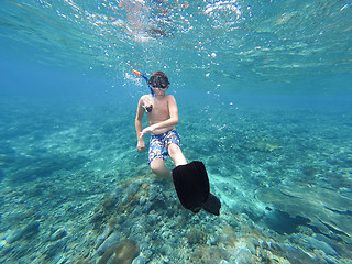 Image showing Underwater shoot of a young boy snorkeling