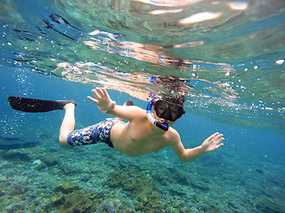 Image showing Underwater shoot of a young boy snorkeling