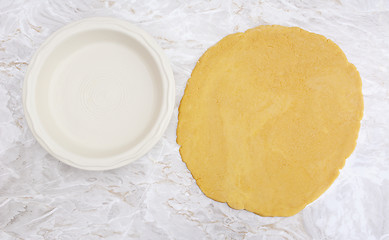 Image showing Fresh pastry rolled out in a circle to line pie dish