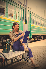 Image showing woman takes notes in notepad and laughing