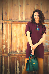 Image showing beautiful middle-aged woman in burgundy dress