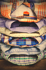 Image showing cotton shirts on a wooden shelf in a clothes store